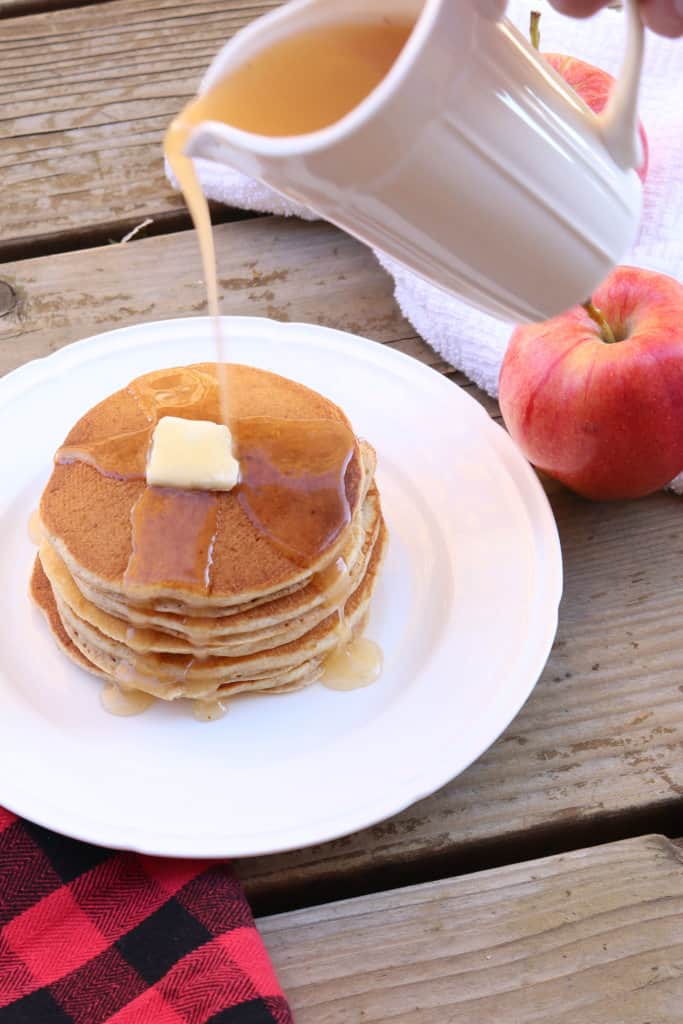 The best homemade apple syrup! This takes less than 5 minutes to make and uses ingredients you already have on hand. Paired with homemade whole wheat pancakes, and this makes a delicious meal. It's a great way to use up leftover apple juice! This would also make great neighbor Christmas gifts or gifts year round.
