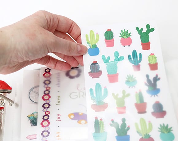 This is the best way to organize stickers! DIY sticker storage binders keep scrapbook and planner stickers organized by categories. Cheap, easy, and compact craft room storage! #stickerstorage #stickerorganization #plannerstickers #scrapbooking #papercrafts #craftroomorganization