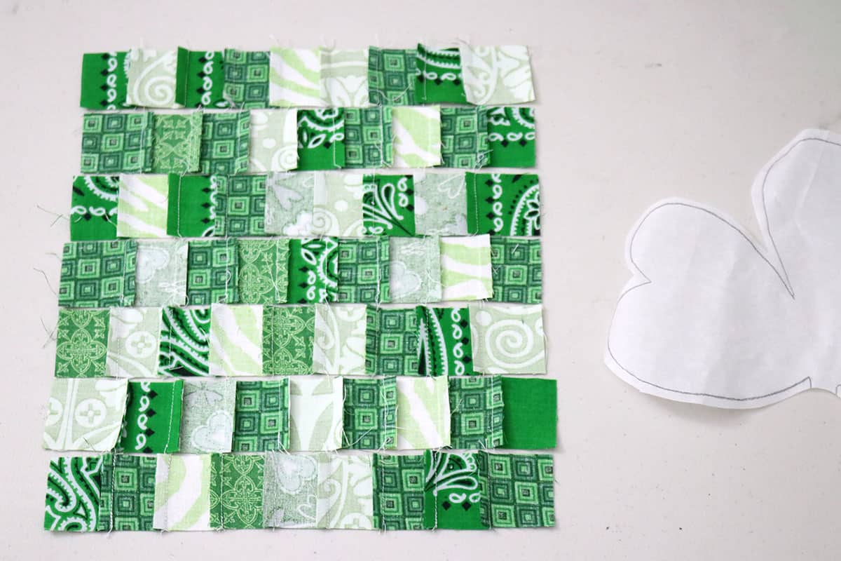 green fabric pieced in rows on table