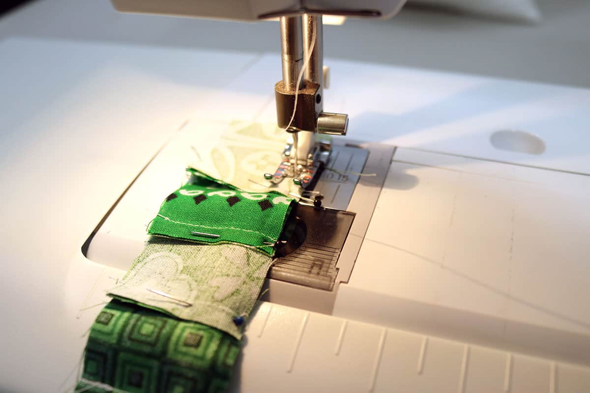 sewing green squares with sewing machine