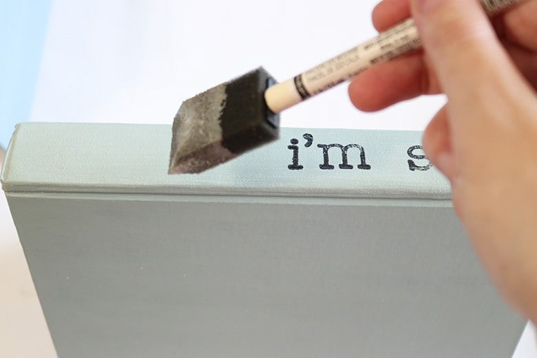 Looking for unique and cheap decor for a table or bookshelf? These chalk-painted and stamped books with custom sayings are so easy to DIY!