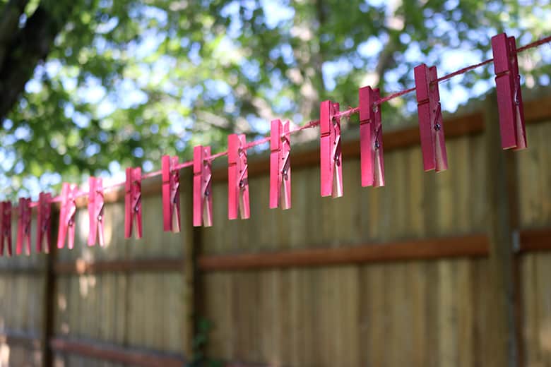 painting clothespins on a line for a clothespin wreath