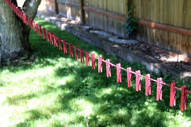 painting clothespins on a line for a clothespin wreath