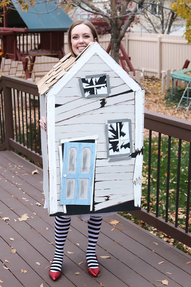 These Wizard of Oz Halloween costumes aren't the typical ones you see over and over! Learn how to make this Wicked Witch of the East and tornado couples costumes--from a box and a laundry hamper! A fun Halloween DIY. #couplescostume #diycostume #halloween #creative #unique #witch #tornado