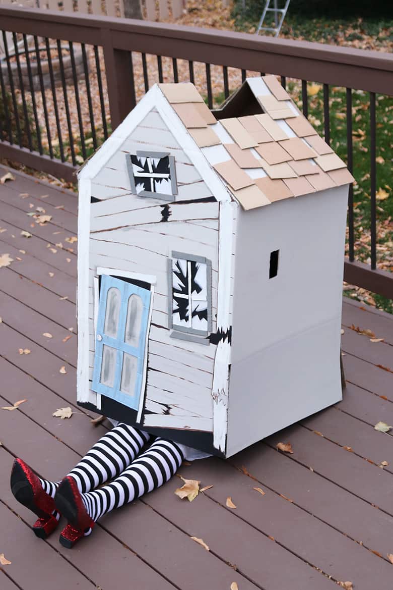 These Wizard of Oz Halloween costumes aren't the typical ones you see over and over! Learn how to make this Wicked Witch of the East and tornado couples costumes--from a box and a laundry hamper! A fun Halloween DIY. 