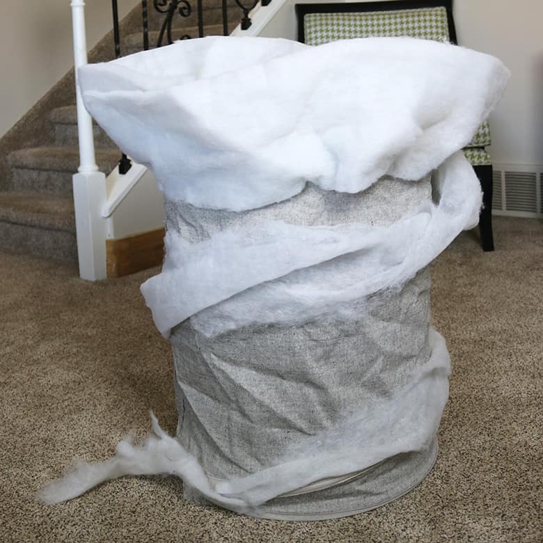 These Wizard of Oz Halloween costumes aren't the typical ones you see over and over! Learn how to make this Wicked Witch of the East and tornado couples costumes--from a box and a laundry hamper! A fun Halloween DIY.