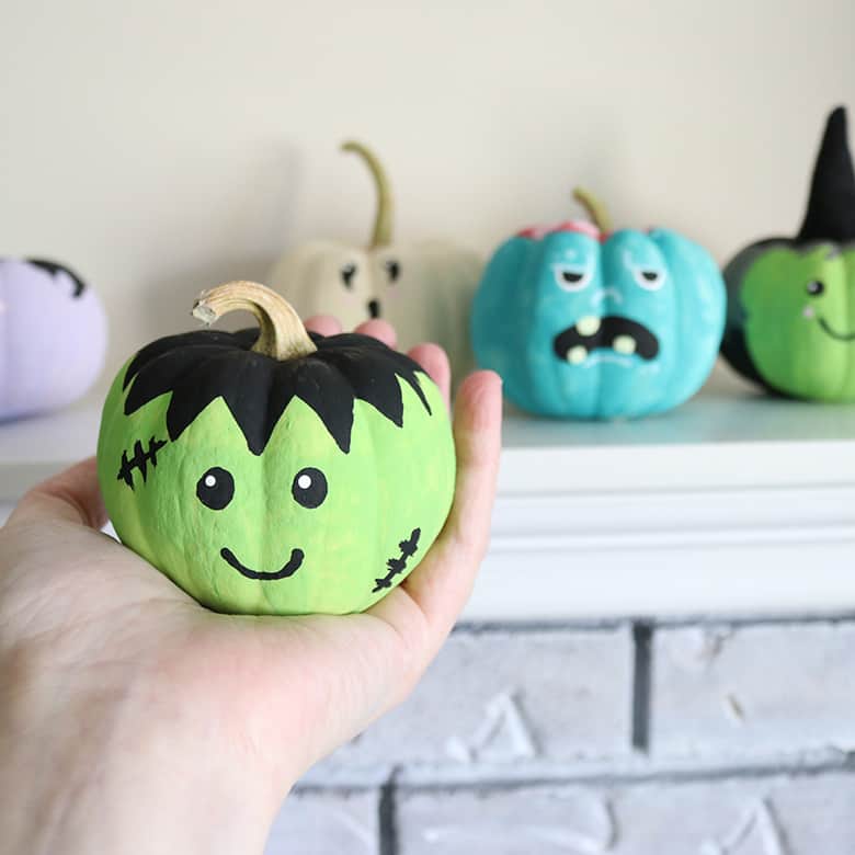 These painted pumpkins with easy monster faces make super cute Halloween decorations! It's a simple pumpkin DIY that even kids can make! A fun Halloween craft using either real or fake pumpkins. 