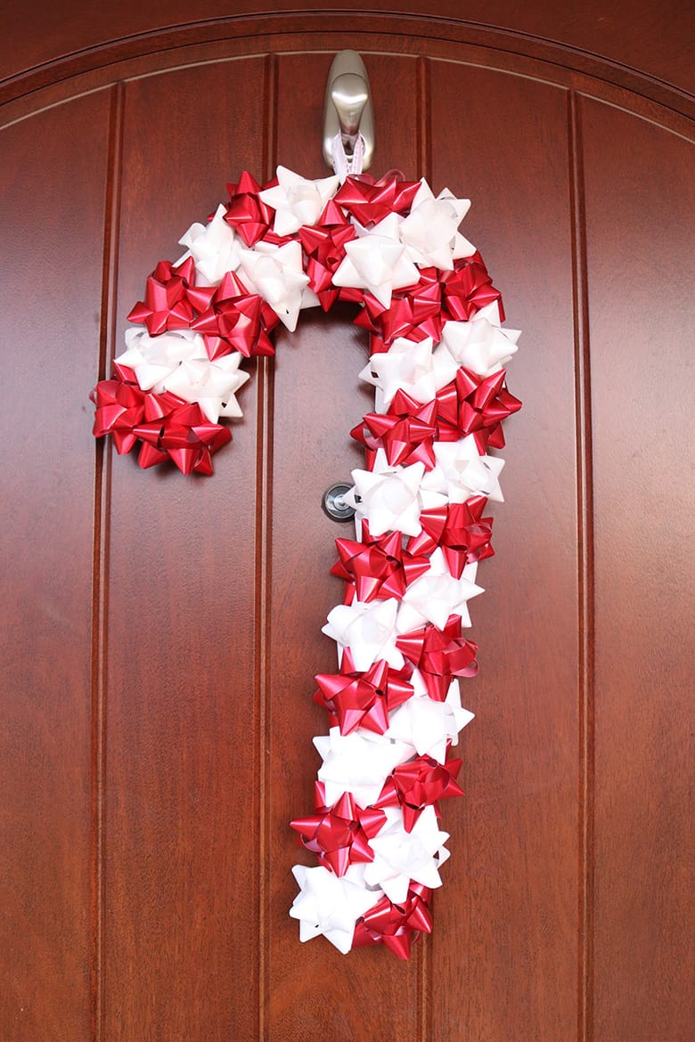 candy cane wreath made with stick-on Christmas bows