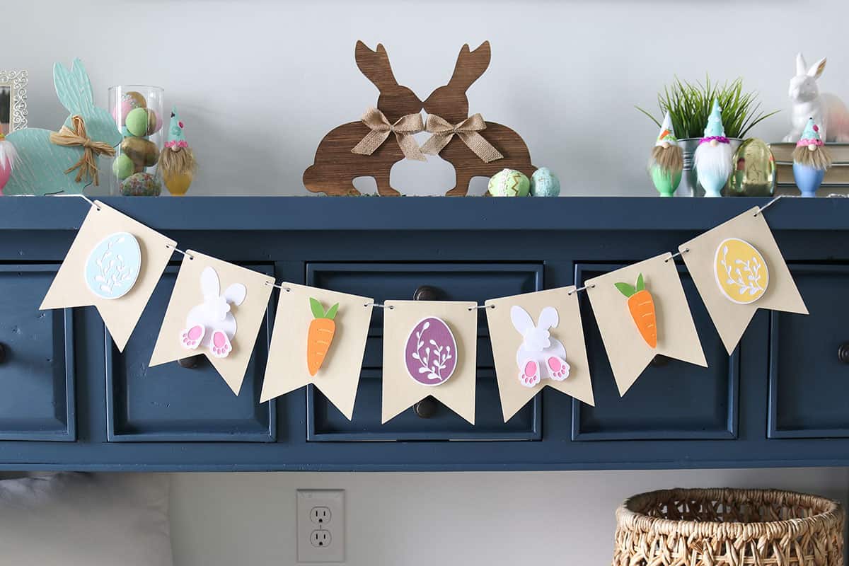 diy easter banner made with Cricut and cardstock, strung on navy blue entry table