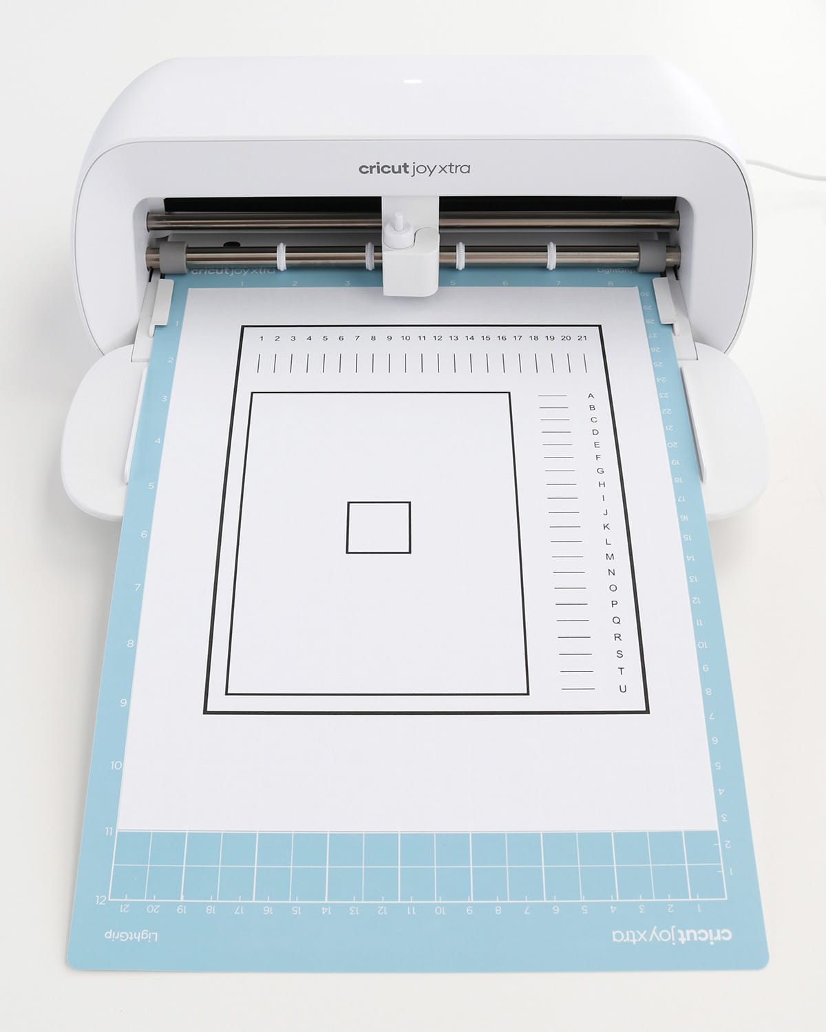 how to calibrate Cricut machines for Print Then Cut, image of Cricut Joy Xtra with calibration sheet loaded on mat
