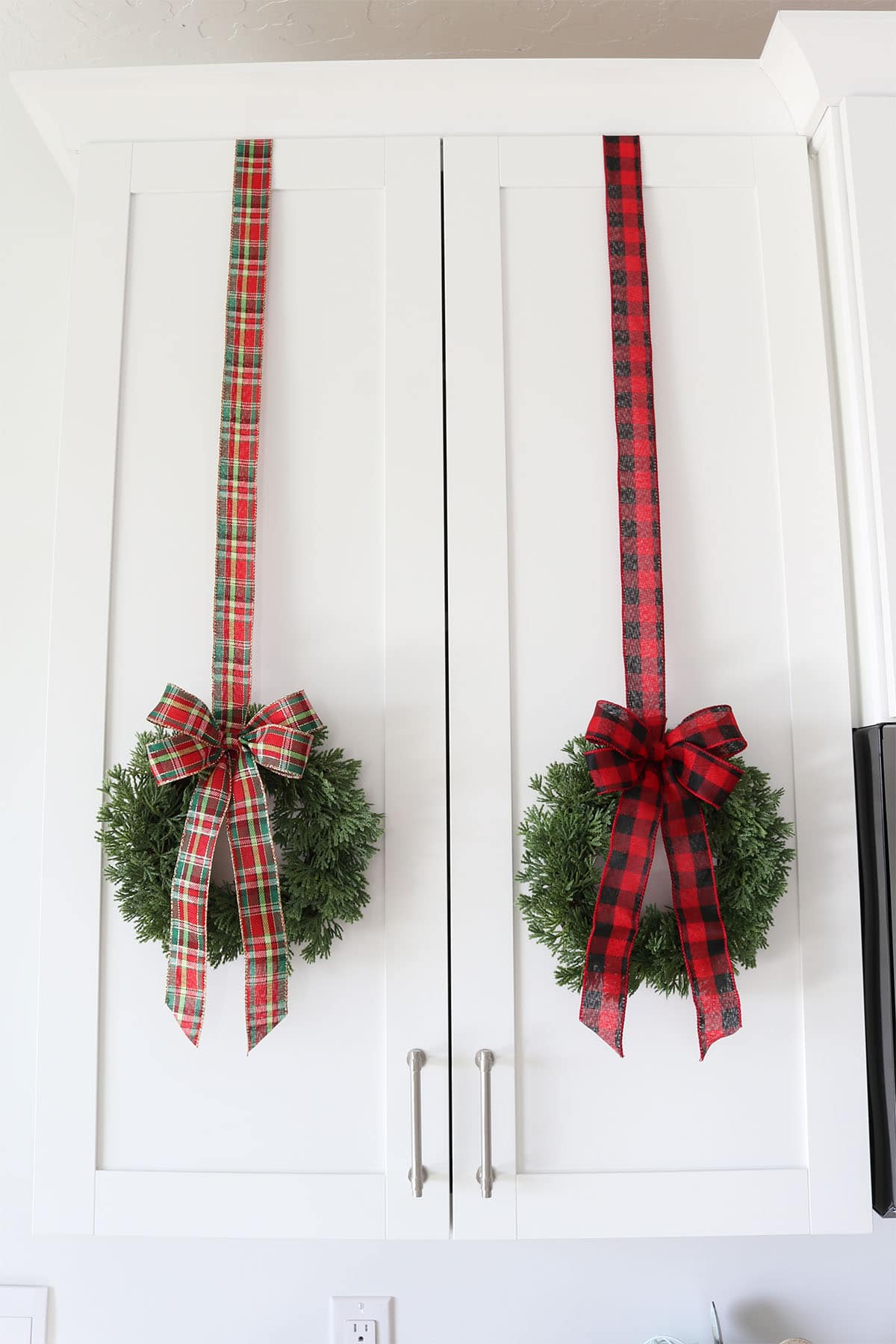 Christmas wreaths on kitchen cabinets