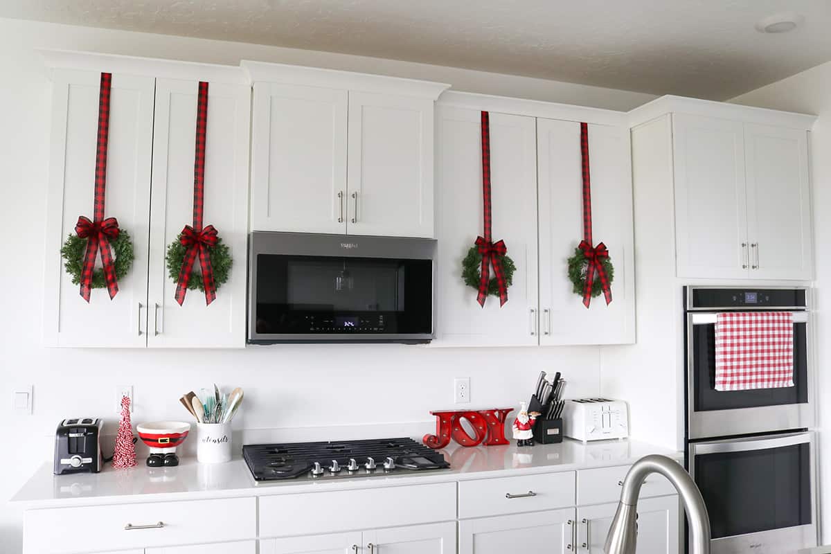 Christmas kitchen with wreaths on cabinets
