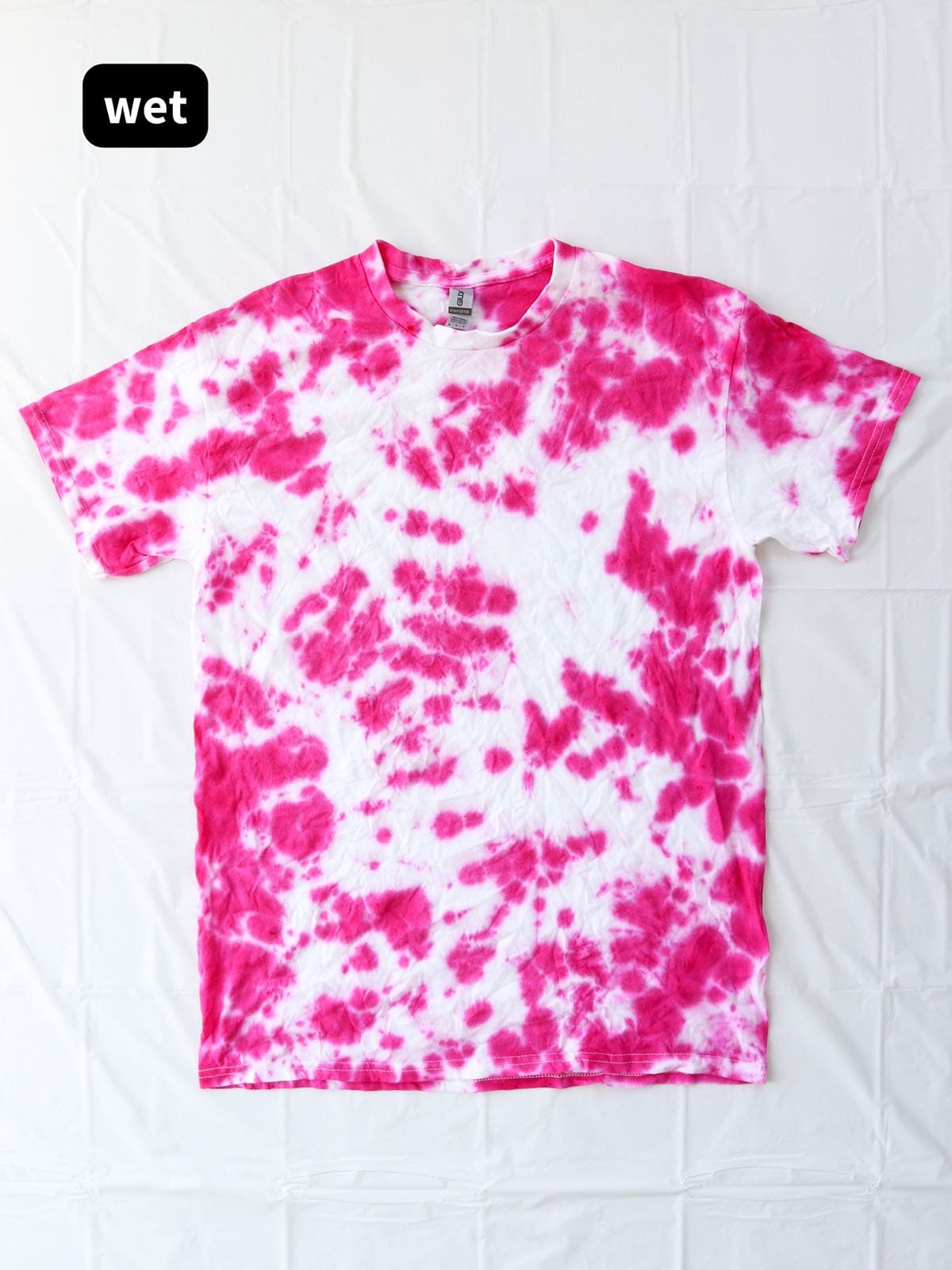 DIY bright pink crumple tie dye shirt before rinsing