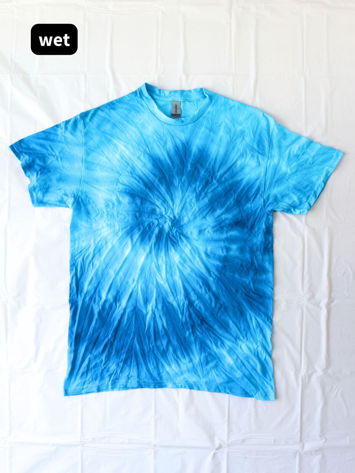 DIY blue monochrome spiral tie dye shirt before rinsing