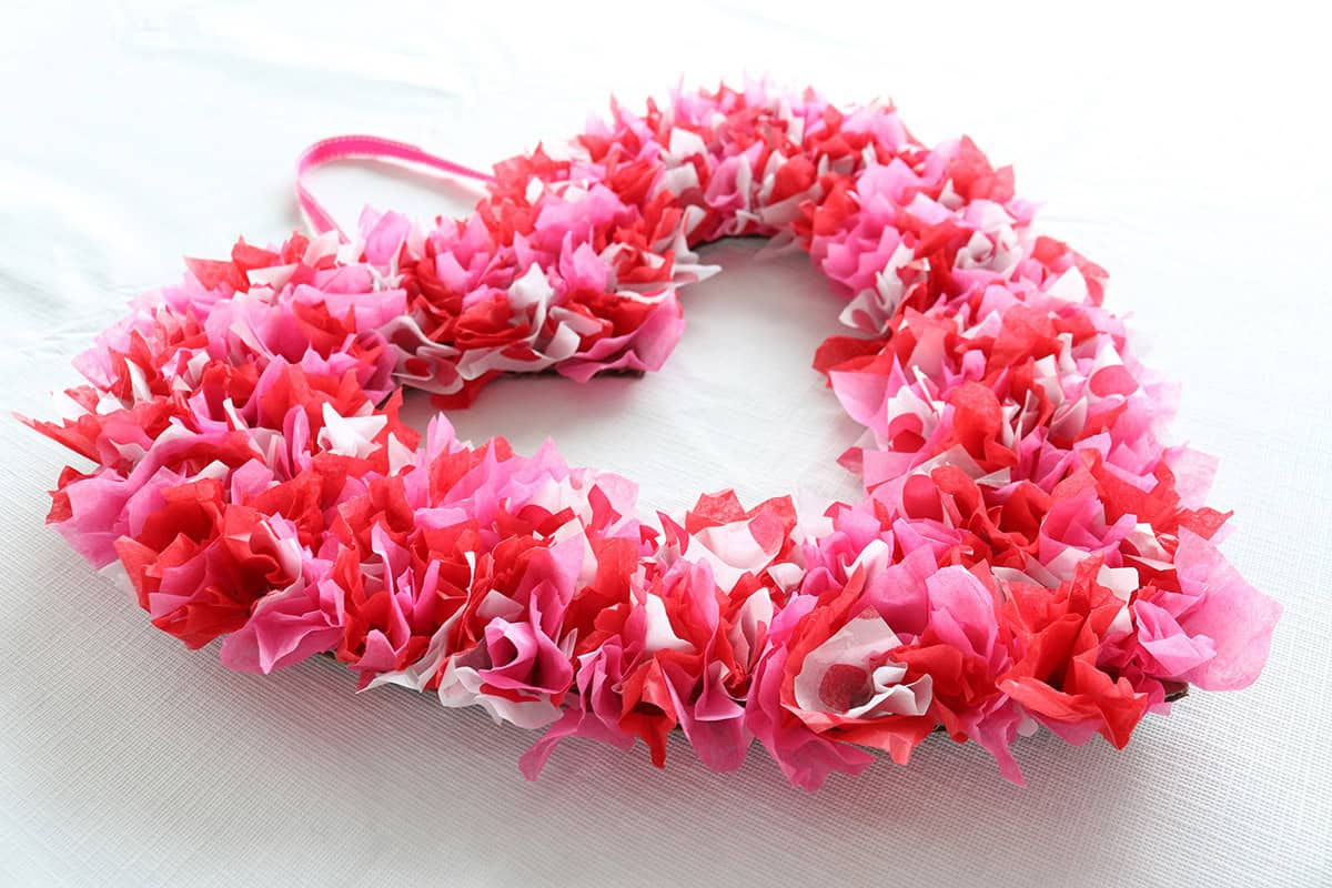 side view of red and pink tissue paper valentine's day wreath, easy craft for kids