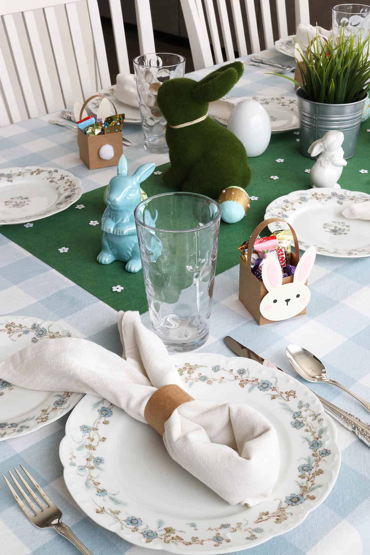 simple and cute easter tablescape with blue gingham tablecloth, limoges china, and bunny decorations
